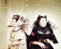 two women in fancy costumes standing next to each other